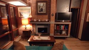 a living room with a fireplace and a tv at Miravalle in Narni