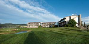 a building on a grassy hill next to a building at Hotel Mas Solà in Santa Coloma de Farners +77 photos