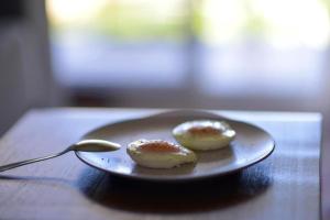 two deviled eggs on a plate with a spoon at Glenview Alpaca Farm in Yass +76 photos