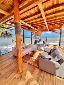 a living room with a hammock and the beach at RCH LUXURY HOTEL & POOL in Dibulla