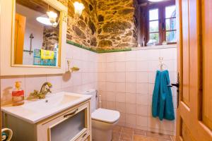 a bathroom with a sink and a toilet at A casa de López in A Coruña