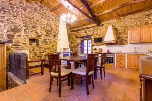 a kitchen and dining room with a table and chairs at A casa de López in A Coruña +13 photos