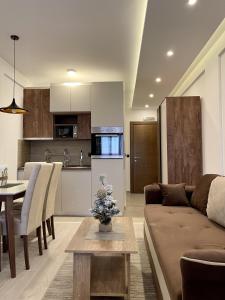 a living room and kitchen with a couch and a table at Milmari N69 in Kopaonik