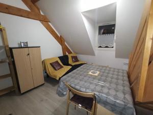 a small room with a bed and a table at Le Therminus, T2Bis au cœur de Luchon in Luchon
