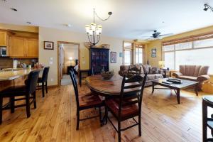 a kitchen and living room with a table and chairs at Aspens 4406 in Big White