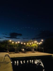 a pool with chairs and lights at night at Cabañas San Miguel in Cortaderas +126 photos