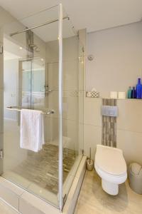 a bathroom with a shower and a toilet at Heaven on Earth - Blouberg Beachfront Self-catering Apartment in Bloubergstrand