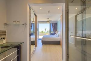 a bedroom with a bed and a view of a bathroom at Heaven on Earth - Blouberg Beachfront Self-catering Apartment in Bloubergstrand