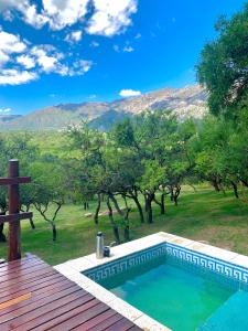 a swimming pool with a view of the mountains at Cabañas San Miguel in Cortaderas