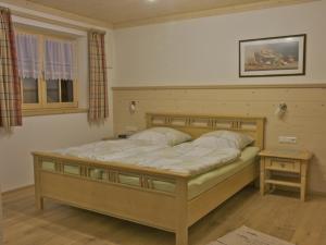 a bedroom with a large bed and a table at Ferienwohnungen Bauregger - Chiemgau Karte in Inzell