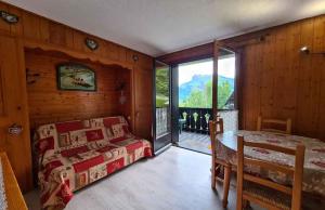 a bedroom with a bed and a large window at Alpenrose Saint Gervais les Bains in Saint-Gervais-les-Bains