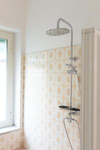a shower stall in a bathroom with a window at Nella's Carlo III Apartment in Naples