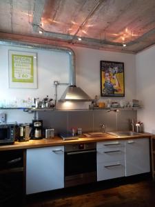 a kitchen with a counter and a stove top oven at Great room in cool house in York