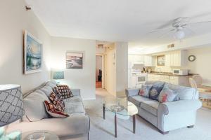 a living room with two couches and a kitchen at Sandalwood 203B in Ocean City