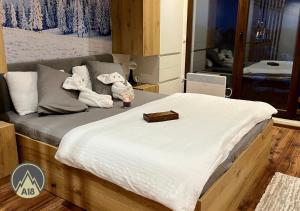 A bed or beds in a room at Lux Apartman A18 & SPA Centar