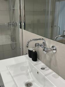 a bathroom sink with a shower and a mirror at Apartamentos Cisneros in Alicante