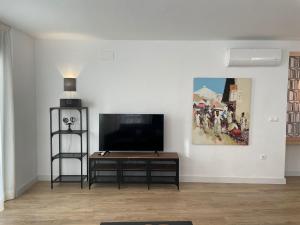 a living room with a flat screen tv on a wall at Apartamentos Cisneros in Alicante