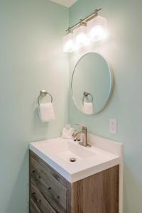 a bathroom with a sink and a mirror at Beachside Inn in Seaside