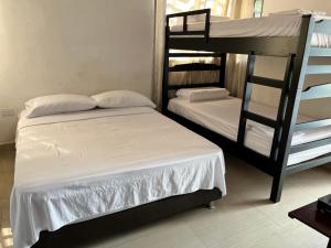 a bedroom with two bunk beds in a room at Blue Sea in Santa Marta