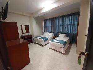 Ein Bett oder Betten in einem Zimmer der Unterkunft Hotel El Andino