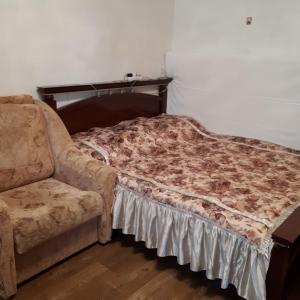 ゼレノグラーツクにあるHome on Chkalova 13のベッド1台と椅子1脚