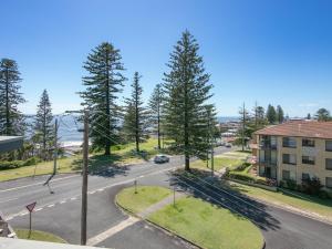an aerial view of a street with trees and a building at Seaspray 2 in Yamba