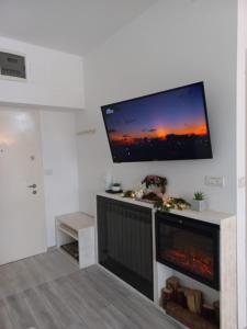 a living room with a large flat screen tv on the wall at WWA SUNLIGHT VIBES in Sinaia