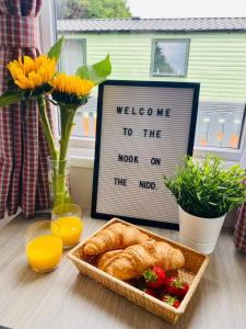 a plate of croissants and a sign with welcome to the knot on at Nook on the Nidd, Knaresborough in Knaresborough
