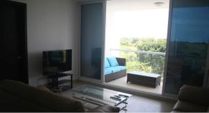a living room with a blue couch and a large window at Panoramic Ocean view Playa Blanca Suite in Playa Blanca