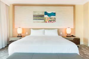 a bedroom with a large white bed with two lamps at Eden Roc Miami Beach in Miami Beach