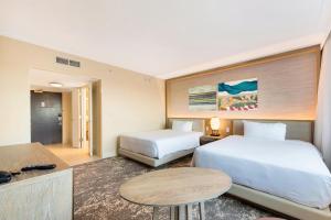 a hotel room with a bed and a desk at Eden Roc Miami Beach in Miami Beach