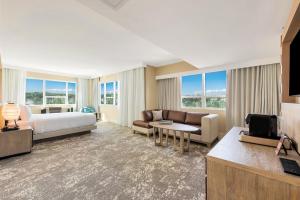a hotel room with a bed and a living room at Eden Roc Miami Beach in Miami Beach +116 photos
