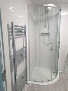 W łazience znajduje się prysznic ze szklanymi drzwiami. w obiekcie Modern self contain studio Own Private Access w mieście Finchley