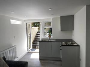a kitchen with a sink and a counter top at Modern self contain studio Own Private Access in Finchley
