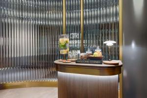 a welcome center with a drink on a table at Radisson Collection Hotel, Berlin in Berlin