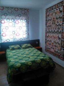 a bedroom with a bed and a window at Atico Mirador al Mar in Alcossebre