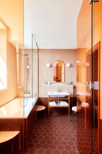 a bathroom with a shower and a sink and a tub at Hotel De Cambis in Avignon