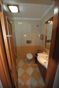 a bathroom with a toilet and a sink at Vila Bairos Apartment Vilamoura in Vilamoura