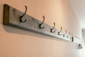 a metal towel rack with hooks on a wall at 7 Rooms Hotel & Cafe in Tokyo