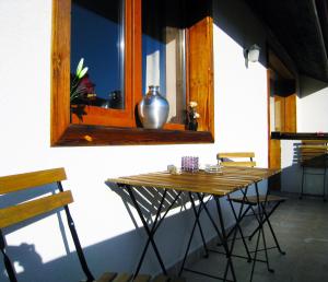 a table in front of a window with a vase on it at Solar nest with fireplace and panoramic view 700m from skilift and centrum in Bansko