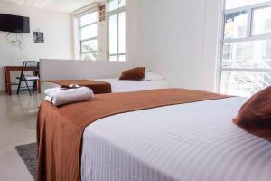 Postel nebo postele na pokoji v ubytování Zuruma Hotel
