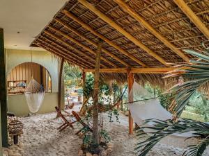 a room with a hammock in a house at Beach Front Guesthouse in Puerto Escondido