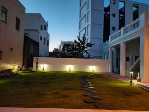 a large grassy yard in a city at night at Day Time Travel B&B 登記編號1033 in Magong