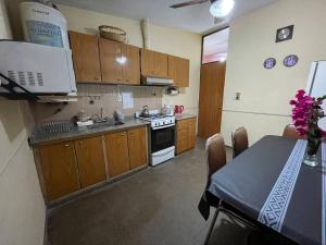 a kitchen with wooden cabinets and a stove top oven at Casa residencial en ubicación preferencial Dorrego in Guaymallen