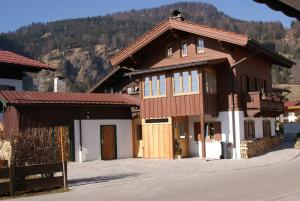 a house with a mountain in the background at Beim Schlenz in Reit im Winkl