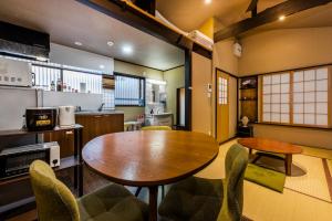 a kitchen and dining room with a table and chairs at Shiki Homes SEN in Kyoto