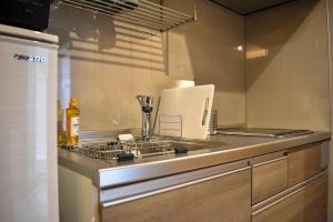 a kitchen counter with a stove and a sink at White Crystal RoomA in Fukuoka