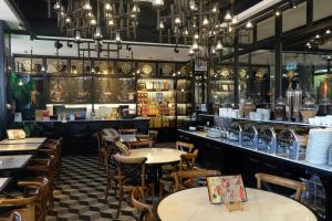 a restaurant with tables and chairs and a bar at M Boutique Hotel in Ipoh