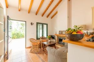 a kitchen and living room with a table and chairs at Rosas Cantares: Casa Maurus. in Pizarra