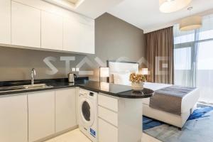 a kitchen with a washer and dryer on a counter at Staycae Holiday Homes - Tower 108 in Dubai